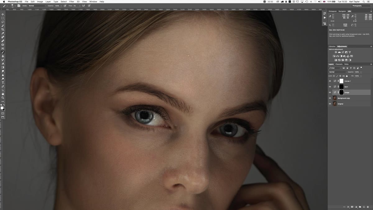 Retoucher zooming out to check tonal balance across full portrait