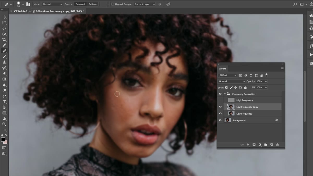 Healing Brush tool active, blending skin tones on the low frequency layer