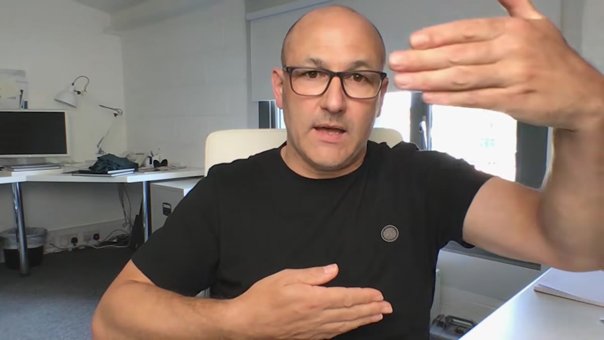 Instructor holding one hand closer to light, showing brightness difference between hands