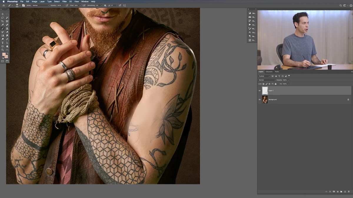 Soft brush strokes covering tattoo area with sampled skin tones