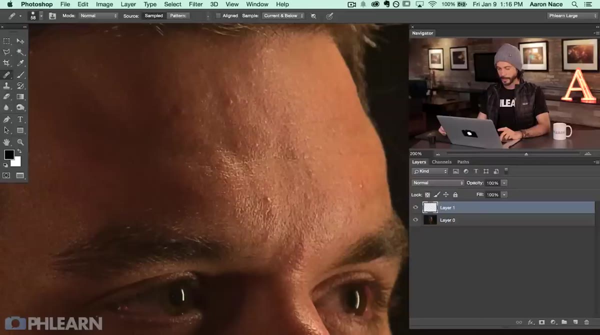 Healing brush being painted over skin imperfections on zoomed-in face