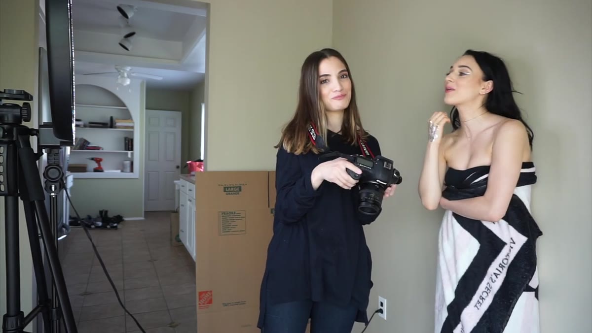 Photographer shows the subject the back-of-camera image during shoot