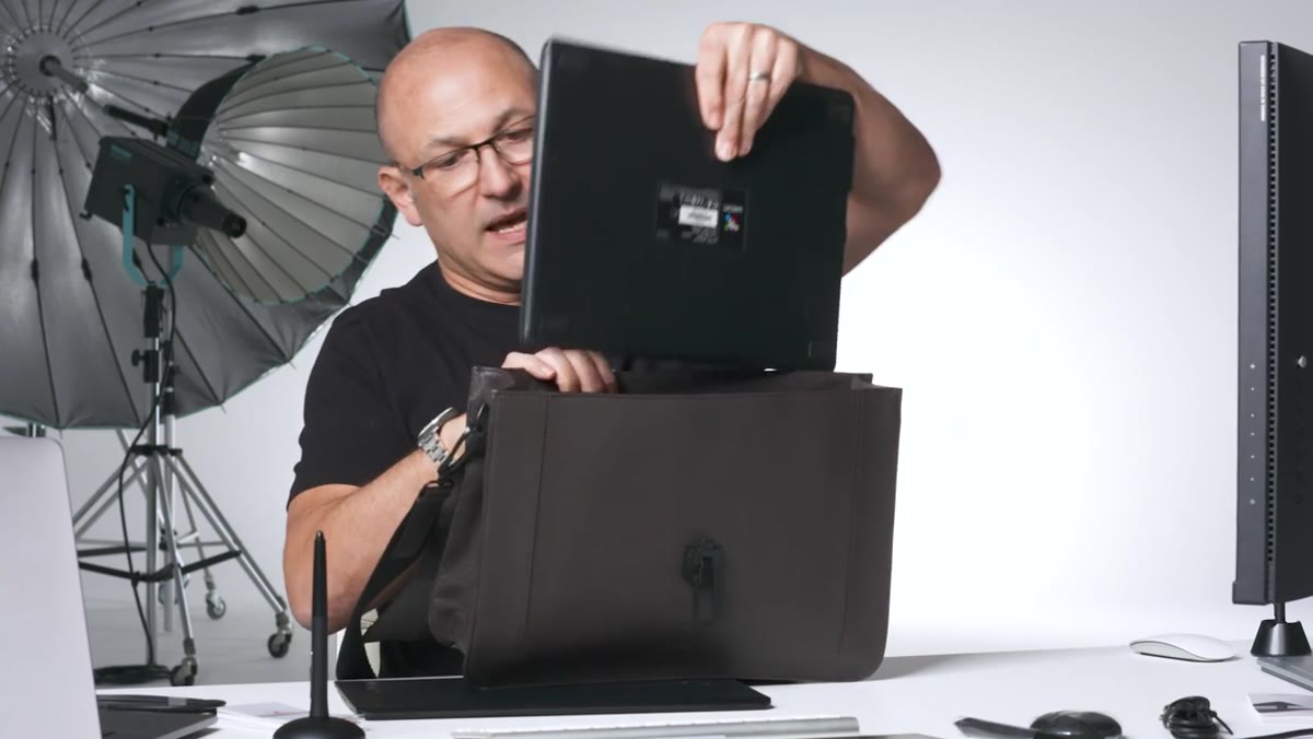 New Medium tablet sliding into a laptop bag alongside a 16-inch MacBook Pro