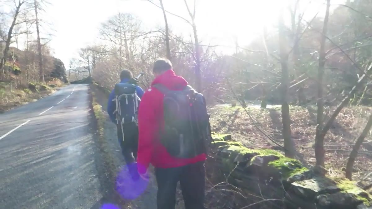 Group of photographers ascending a fell with camera gear